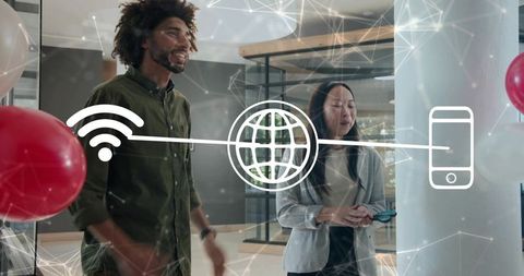 Discussing network connectivity with mobile and wifi icons overlay in modern office workspace