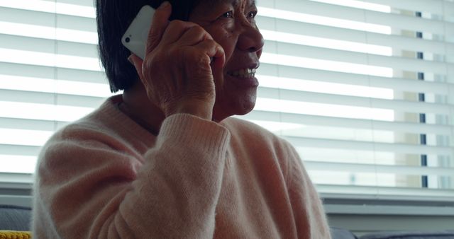 Elderly Woman Talking on Phone by Window - Download Free Stock Images Pikwizard.com