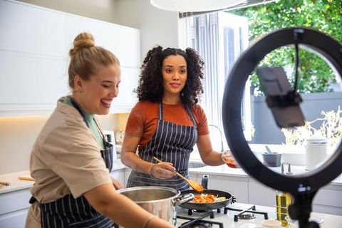Diverse friends cooking together in modern kitchen setting