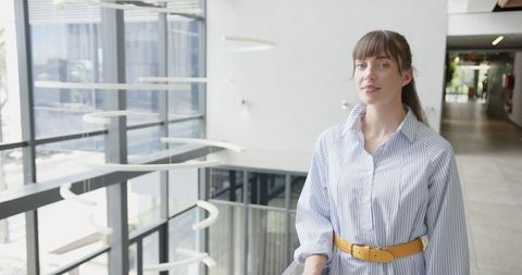 Confident Businesswoman Standing in Modern Corporate Environment