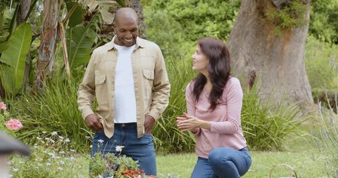 Couple Gardening Together in Vibrant Backyard Setting