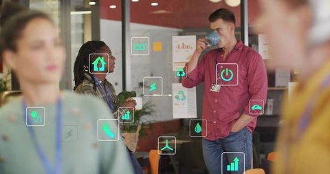 Coworkers collaborating with animated energy icons on glass panel dashboard