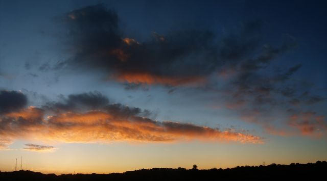Serene Sunset Over Dark Silhouette Landscape - Download Free Stock Photos Pikwizard.com