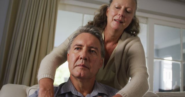 Mature Woman Comforting Elderly Man in Living Room - Download Free Stock Photos Pikwizard.com