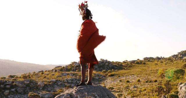 Person in Traditional Attire Standing on Rock in Landscaped Area - Download Free Stock Images Pikwizard.com