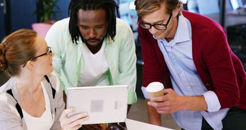 Diverse Team Collaborating with Digital Tablet and Coffee