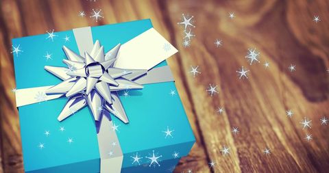 Festive Blue Gift Box with Snowfall Overlay on Wood Background - Download Free Stock Images Pikwizard.com
