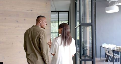 Colleagues Discussing Project in Modern Office Hallway