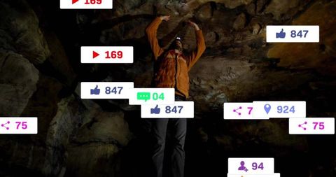 Adventurer reaching cave ceiling surrounded by social media icons