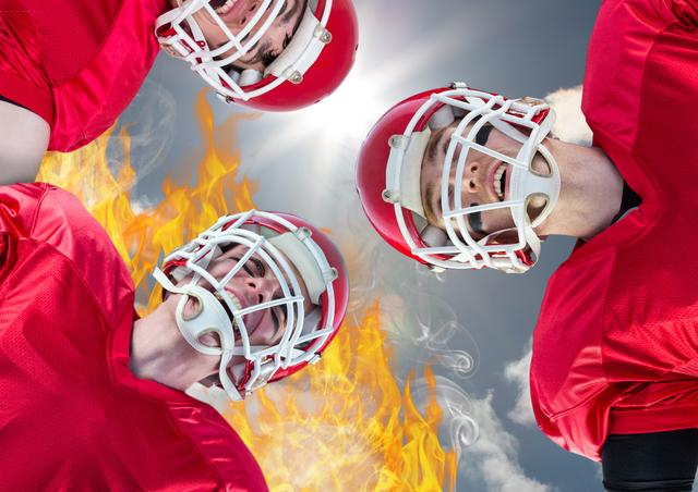 This image depicts a group of football players in red jerseys and helmets, looking intense and ready for action. Flames and a dramatic sky with clouds add to the sense of intensity and competition. This visual is perfect for themes related to sports, teamwork, determination, and competitive spirit. Suitable for promotional materials, sports event advertisements, team building posters, and motivational content.