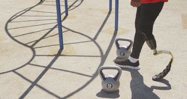 Athlete with Prosthetic Leg Training Outdoors with Kettlebells - Download Free Stock Images Pikwizard.com