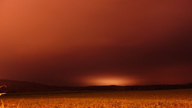 Dramatic Sunset Over Field with Stormy Sky - Download Free Stock Photos Pikwizard.com