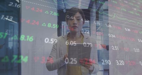 Businesswoman Processing Financial Data on Tablet in Modern Office