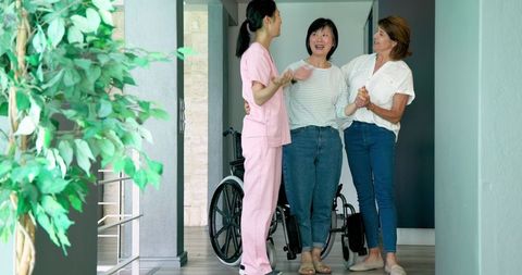 Caring Nurse Assisting Senior Woman with Wheelchair