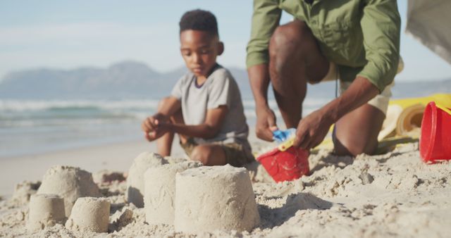 Father and Son Building Sandcastles on a Sunny Beach - Download Free Stock Images Pikwizard.com