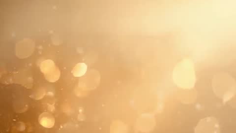 Golden bokeh particles drifting across frame with warm right-side glow and soft sparkle