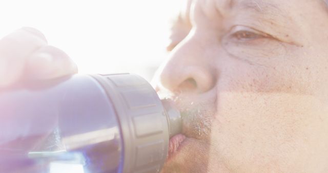 Person Drinking Water from Bottle in Bright Sunlight - Download Free Stock Images Pikwizard.com