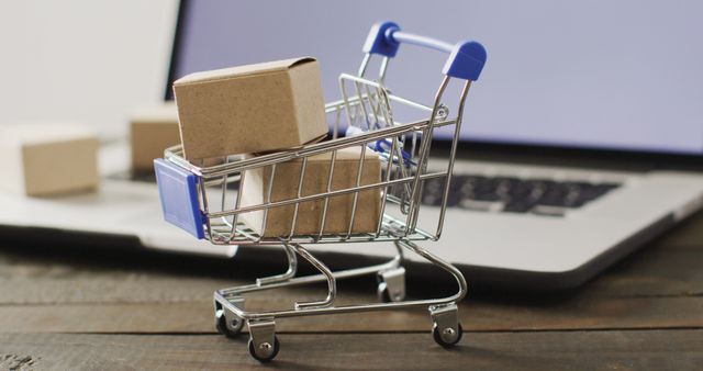 Online Shopping Concept with Mini Shopping Cart and Packages - Download Free Stock Photos Pikwizard.com