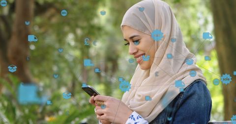 Woman in Hijab Interacting Online Using Smartphone in Park