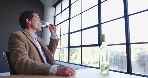 Businessman Drinking Wine in Office for Relaxation - Download Free Stock Images Pikwizard.com