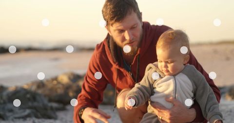 Father enjoying outdoor moment with toddler in warm light