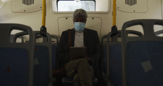 Elderly Man Wearing Mask Using Tablet on Public Bus - Download Free Stock Images Pikwizard.com