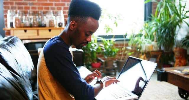 Focused Man Working on Laptop in a Cozy Home Office Setting - Download Free Stock Images Pikwizard.com