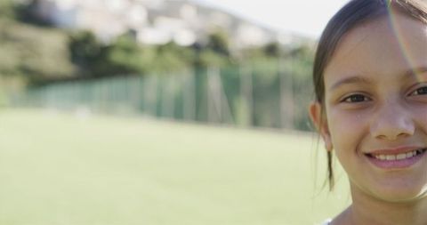 Smiling Biracial Girl in Sunny Playground