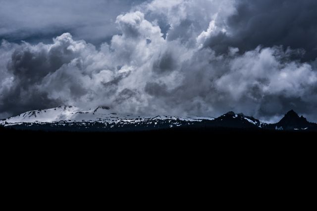 Dramatic Storm Clouds over Snowy Mountain Peaks at Twilight - Download Free Stock Photos Pikwizard.com