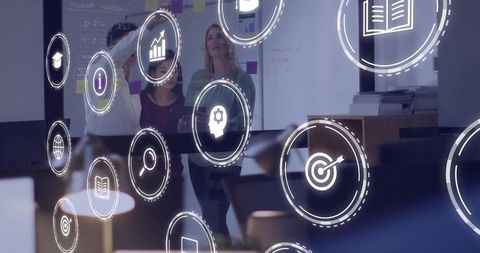Business Team Brainstorming on Glass Wall with Augmented Reality Interface Icons