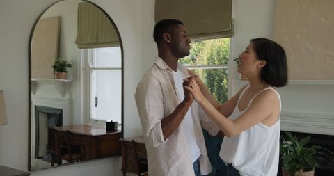 Romantic couple dancing in cozy bedroom captivates heartfelt moment