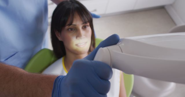 Caucasian male dentist preparing female patient on chair at modern dental clinic. healthcare and dentistry business.