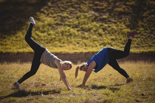 Portrait of beautiful women praising yoga during obstacle course in boot camp