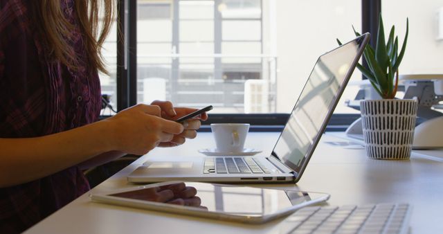 Woman Energized Multitasking with laptop, Phone, Tablet in Modern Office - Download Free Stock Images Pikwizard.com