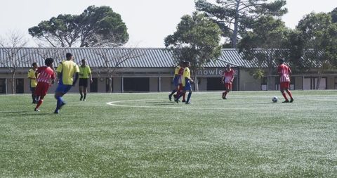 Youth soccer players strategizing on field during match preparation