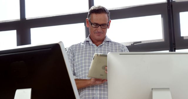 Mature Professional Using Tablet at Modern Office - Download Free Stock Images Pikwizard.com