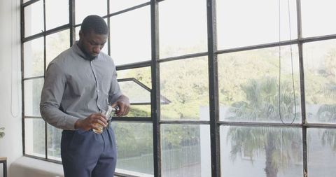Businessman Pouring Refreshing Drink Amidst Work Break