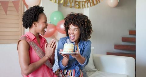 Joyful Birthday Celebration with Cake and Laughter at Home