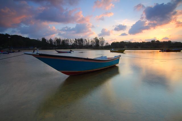 Colorful Boat Floating on Calm Water at Sunset - Download Free Stock Photos Pikwizard.com