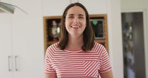 Happy Woman Smiling in Modern Bright Kitchen