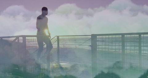 Man Running Against Ocean Backdrop with Mystical Clouds