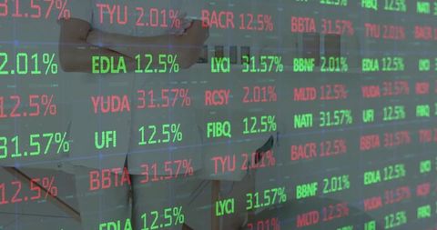 Businesswoman Monitoring Stock Ticker in Modern Office Environment