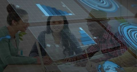 Designers collaborating over holographic charts and color palette on laptop