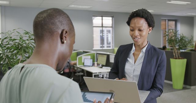 Two Businesswomen Discussing Data in Modern Office Environment - Download Free Stock Images Pikwizard.com