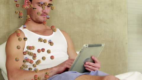 Caucasian Man Using Tablet with Emojis Floating Around