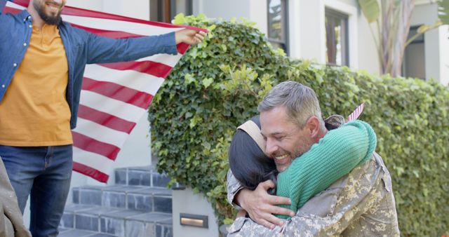 Military homecoming capturing returning soldier hugging family member with American flag displayed, conveying emotions of joy and love. Perfect for themes on support for military, family reunions, patriotism, national pride, and emotional moments. Ideal for use in articles, blogs, social media campaigns, and advertisements focusing on military families, veterans, and homecoming celebrations.