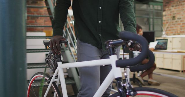 Person Walking with Bicycle in Urban Office Environment - Download Free Stock Images Pikwizard.com