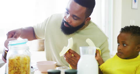 Father and Son Sharing Breakfast in Dining Room