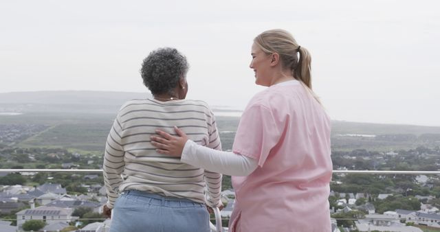 Caregiver Comforting Elderly Woman on Balcony with Scenic View - Download Free Stock Images Pikwizard.com