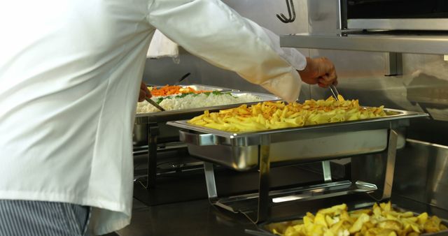 Chef Preparing Buffet with Fries and Vegetables in Professional Kitchen - Download Free Stock Images Pikwizard.com